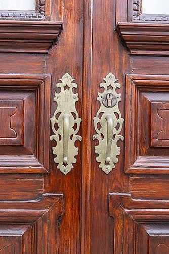 Angra do Heroismo, Terceira Island, Azores, Portugal. Brass handles on old wooden doors. European Print